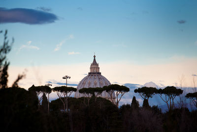 Low angle view of historic building and trees against sky