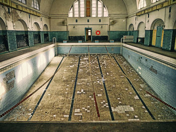 Empty swimming pool in abandoned building