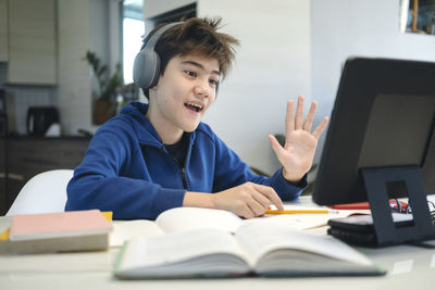 Portrait of boy sitting on table