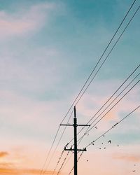 Low angle view of electricity pylon against sky