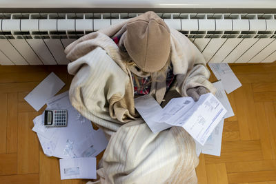 Worried  woman reading heating bill, high bill tax invoice, debt notification, bad financial report