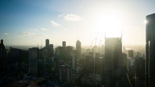 Aerial view of buildings in city against sky