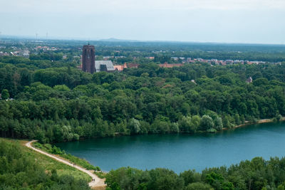 Scenic view of river by buildings in city against sky