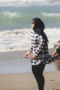 Full length of woman standing at beach