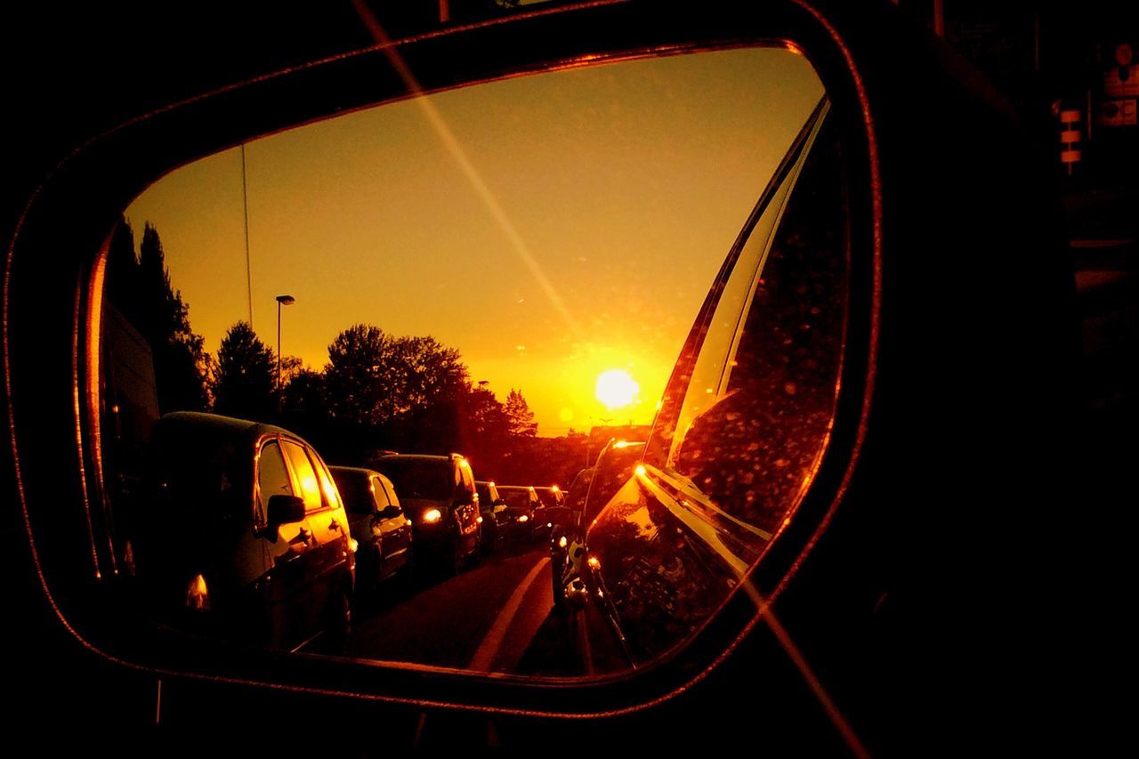 transportation, land vehicle, mode of transport, car, sunset, road, on the move, travel, vehicle interior, street, headlight, windshield, car interior, glass - material, side-view mirror, sky, traffic, illuminated, transparent, motion