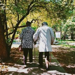 Rear view of couple walking on pathway
