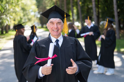 Portrait of woman wearing graduation gown