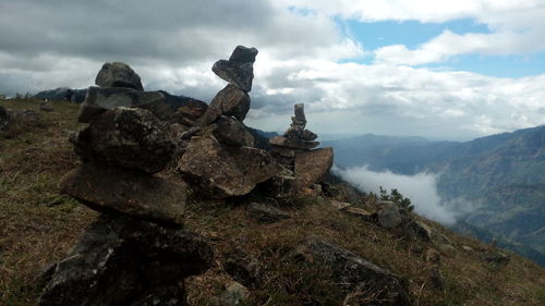 View of sculpture on mountain against cloudy sky