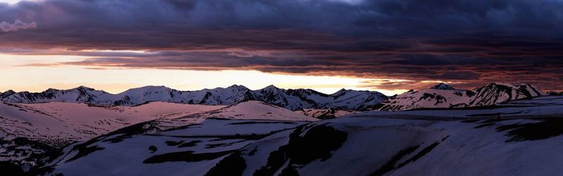 Scenic view of snowcapped mountains against sky during sunset