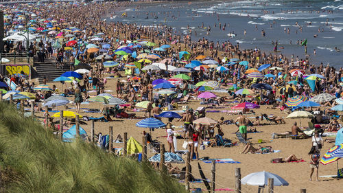 High angle view of people enjoying at beach