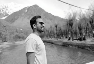 Portrait of young man standing on mountain