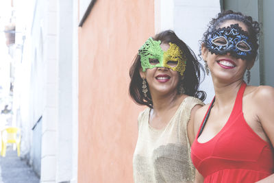 Portrait of two women wearing venice carnival mask. 