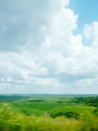 Scenic view of landscape against cloudy sky