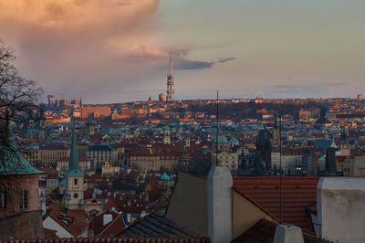 Cityscape against cloudy sky