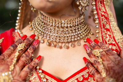 Midsection of woman wearing jewelry