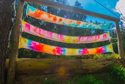 Low angle view of multi colored flags on field