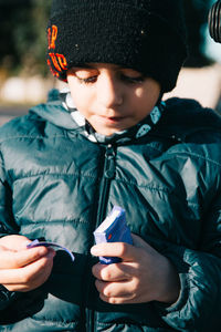 Boy eating candy outdoors