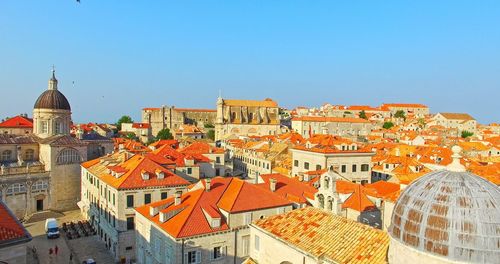 View of buildings in city against clear sky