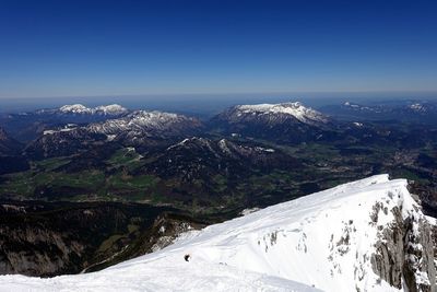 Scenic view of snowcapped mountains against clear blue sky