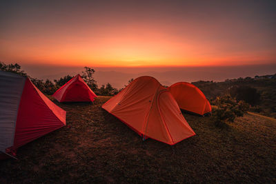 Tent on field against sky during sunset