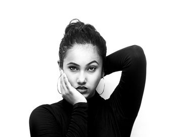 Portrait of young woman against white background