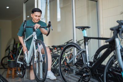 Portrait of young man riding bicycle on street