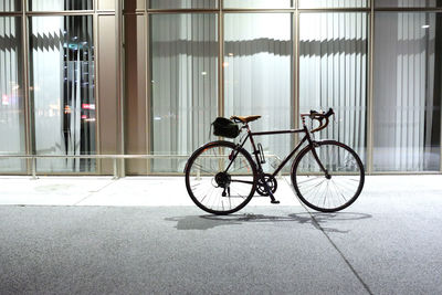 Side view of bicycle against building