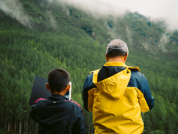 Rear view of man standing on mountain