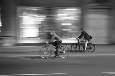 Man riding bicycle on street in city