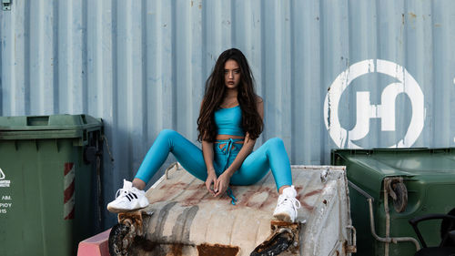 Portrait of young woman sitting on seat