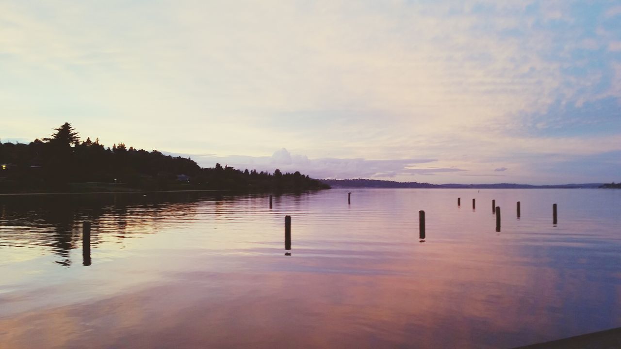 water, tranquil scene, tranquility, reflection, sky, lake, scenics, beauty in nature, sunset, nature, waterfront, idyllic, pier, cloud - sky, calm, silhouette, cloud, dusk, outdoors, non-urban scene