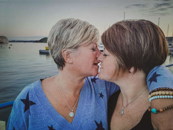 Portrait of a couple with water at shore