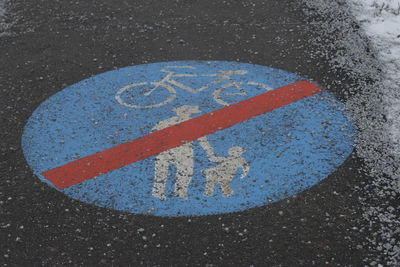 High angle view of arrow sign on road in city