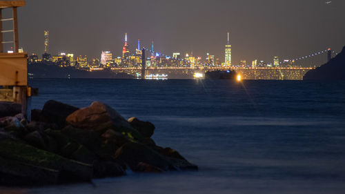 Illuminated city at waterfront