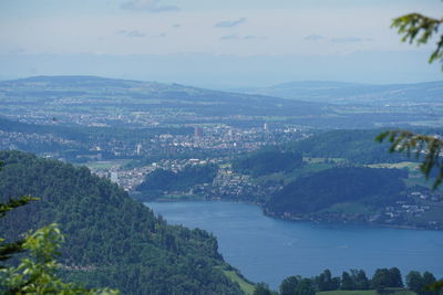 High angle view of townscape by sea against sky