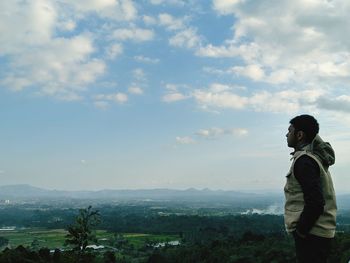 Man standing on mountain against sky