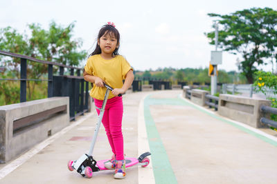 Portrait of young woman exercising on road