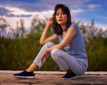 Young girl in the evening scenery. beautiful woman outside the house on a sunny day