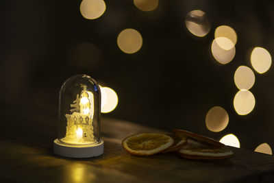 Close-up of illuminated light bulbs on table