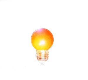 Close-up of light bulb against white background