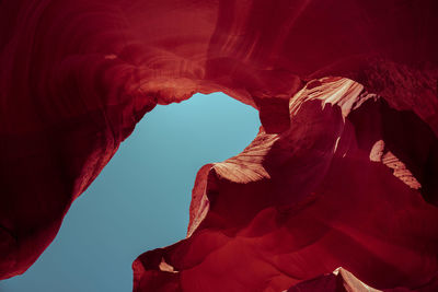 Low angle view of red rock formation against sky