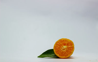 Close-up of orange slice against white background