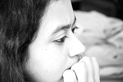 Close-up of worried woman biting nails