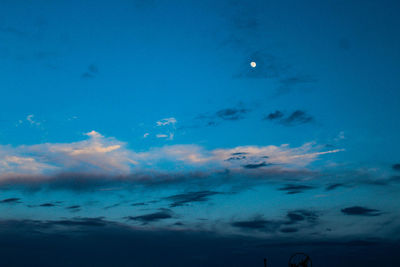 Low angle view of moon in blue sky