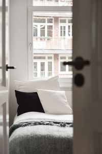 View from the door to a sofa with pillows