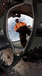 Reflection of man on side-view mirror during winter
