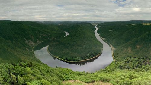 Scenic view of river amidst landscape against sky