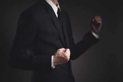 Midsection of a man against black background