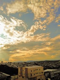 High angle shot of townscape against sky at sunset