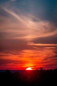 Scenic view of silhouette landscape against romantic sky at sunset